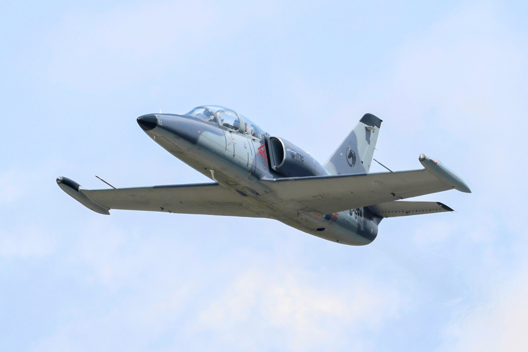 Grey L39 flying with blue sky