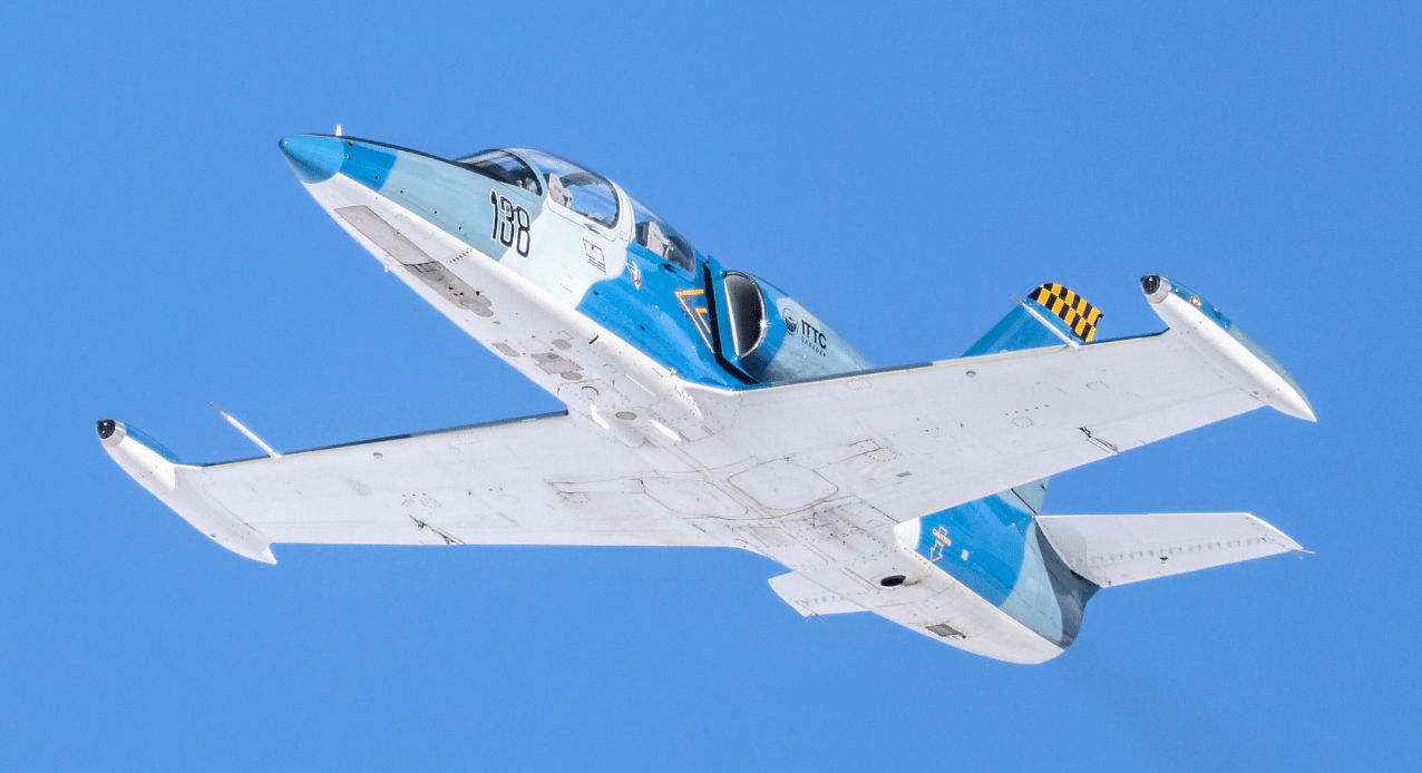 Blue L39 flying under blue sky