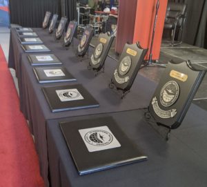 Photo of plaques and certificates on a long table for Fighter Lead-In Training course.
