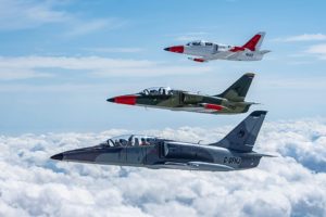Photo of blue cloudy skies with three jet airplanes flying in formation.