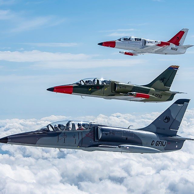 ITTC L-39 Form 005 Photo of blue cloudy skies with three jet airplanes flying in formation.