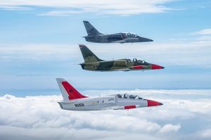 Photo of blue cloudy skies with three jet airplanes flying in formation.