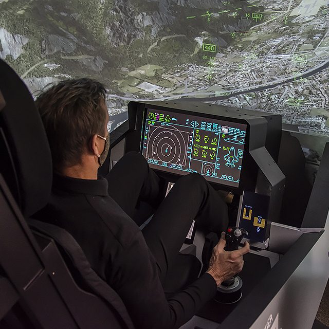 Photo of Billie Flynn in F-35 aircraft simulator.