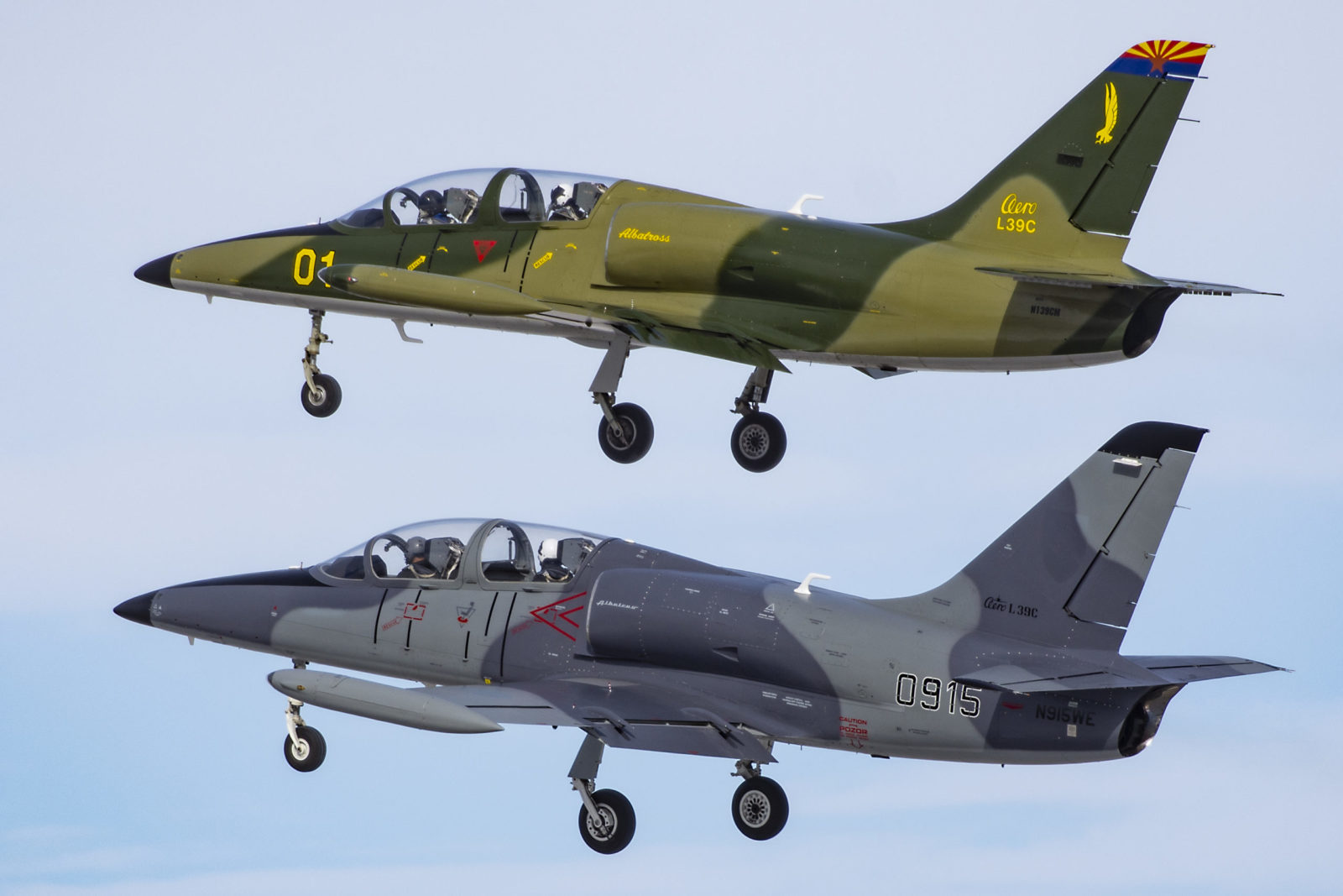 yxu2020230213 Photo of two L-39 aircraft in the sky with landing gear down.