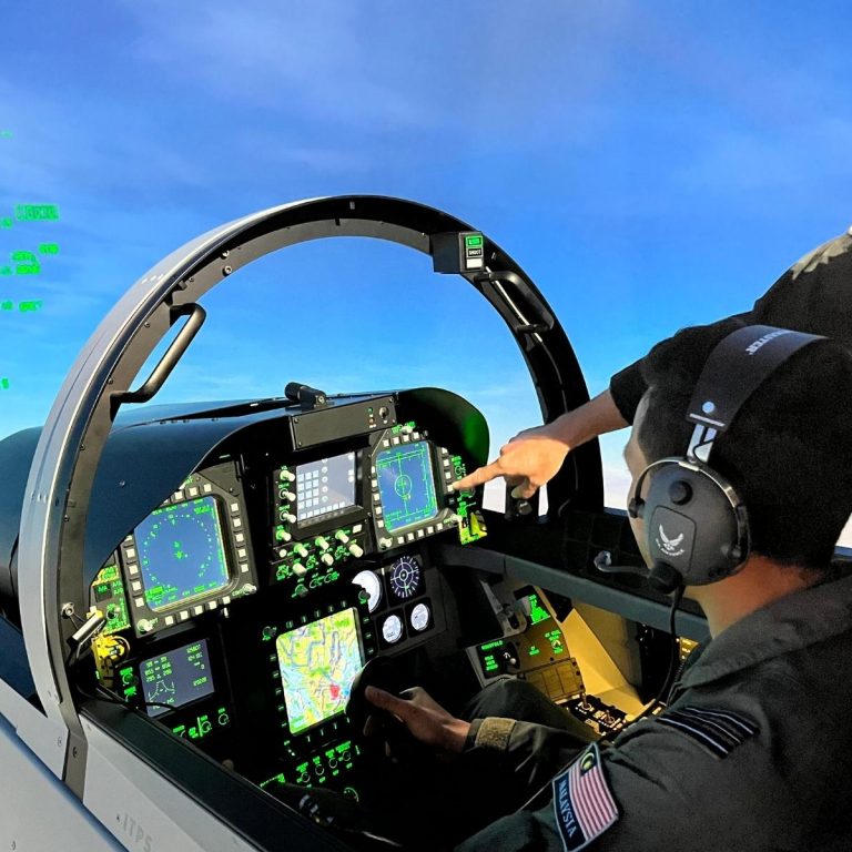 Sugar and RMAF Student Duane Sugar Lecaine with student in F/A-18E simulator