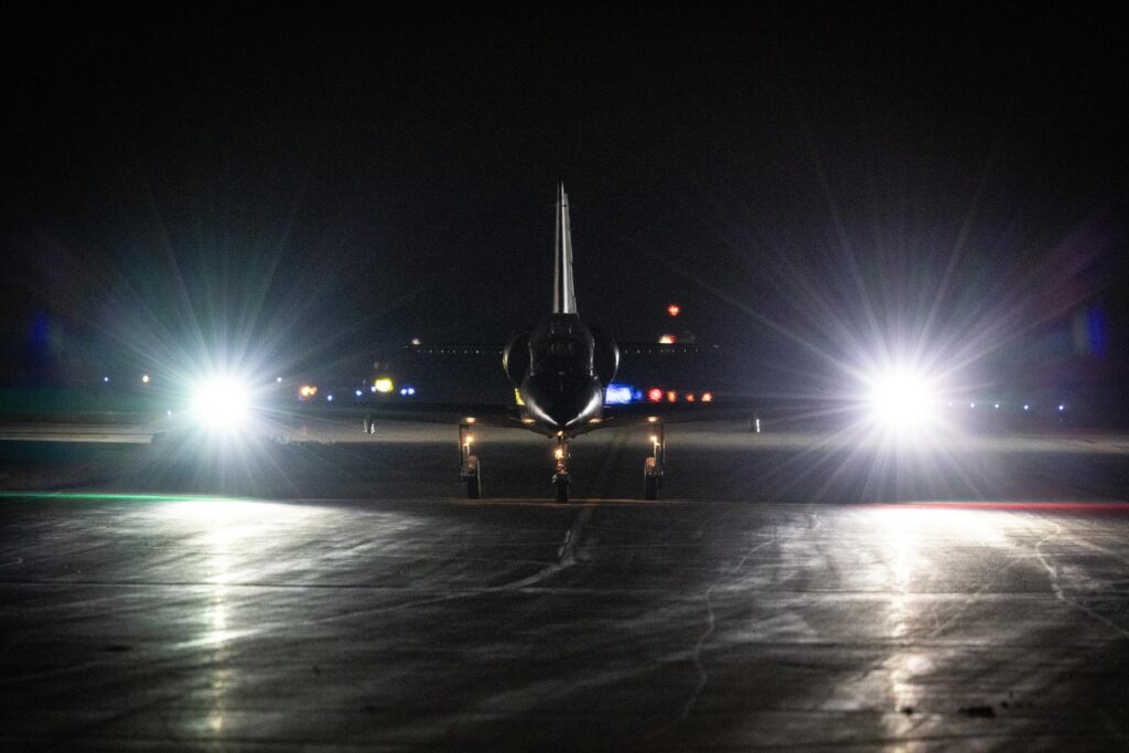 y L39 on taxi way during night sorties with lights on
