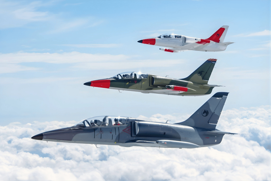 three L39 jets in formation flying above clouds