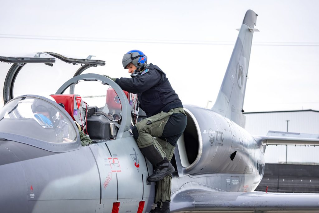 Tactical instructor pilot climbing into rear L39 cockpit