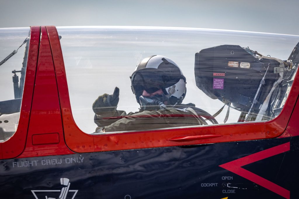 Tactical instructor pilot in rear cockpit giving thumbs up